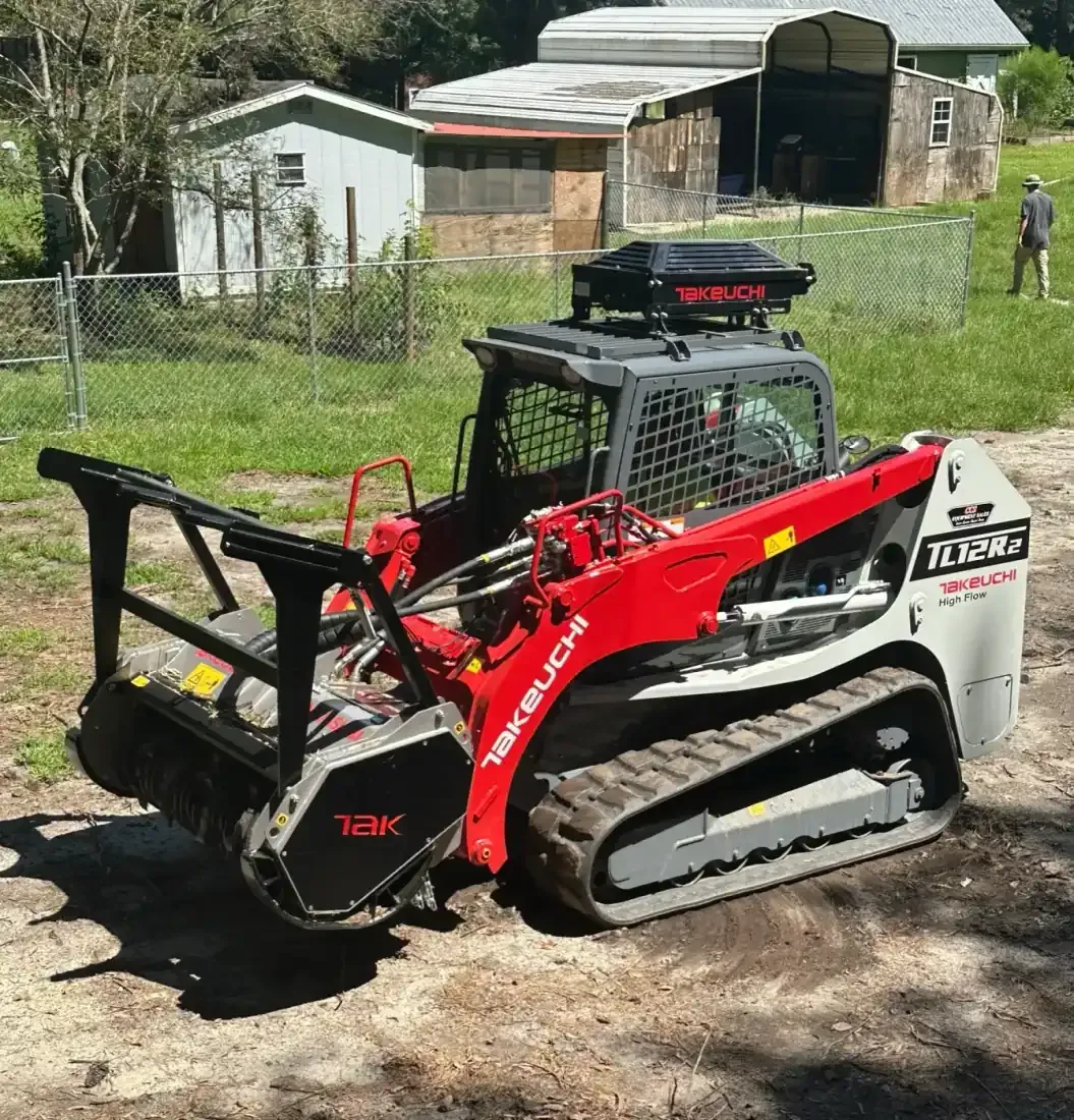 Takeuchi TL12R2 with FAE mulcher head clearing brush on a wooded lot in Eastern NC